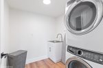 Laundry room with stacked washer/dryer units. 